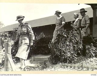 VFX361 COLONEL A.M. SAGE, RRC, MATRON-IN-CHIEF, AUSTRALIAN ARMY NURSING SERVICE, LEAVES THE OFFICERS' WARD AFTER HER INSPECTION, FOLLOWED BY NFX76276 MATRON M.E. HURLEY, (2), NFX281 SISTER S.J. ..