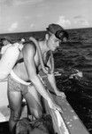 Robert Floyd Dill works from a motor launch at Alexa Bank, Samoa