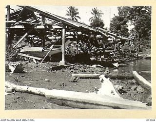 ALEXISHAFEN, NEW GUINEA. 1944-05-16. THE DAMAGED BOATSHED AT THE OLD CATHOLIC MISSION. THE MISSION, THE PRESENT CAMP SITE OF THE 2/15TH FIELD AMBULANCE, CONTAINS MANY BUILDINGS WHICH HAVE BEEN ..