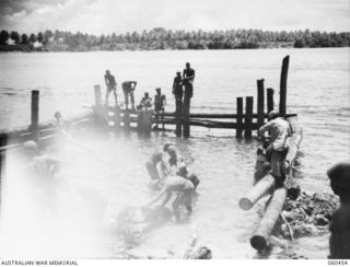 FINSCHHAFEN AREA, NEW GUINEA. 1943-11-09. COLOURED ENGINEERS OF THE 870TH UNITED STATES ENGINEER AVIATION BATTALION BUILDING NEW DOCK APPROACHES AT DREGER HARBOUR