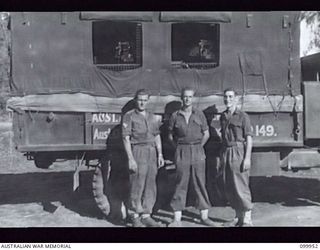 RABAUL, NEW BRITAIN, 1946-03-30. THE CREW OF UNIT NO 149, MOBILE CINEMA HQ, AUSTRALIAN ARMY AMENITIES SERVICE. IDENTIFIED PERSONNEL ARE: SERGEANT R. CARTLEDGE, CHIEF OPERATOR (1), CORPORAL J. ..