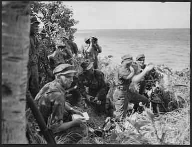 World War 2 New Zealand troops, on Nissan Island, Papua New Guinea, firing at Japanese barges