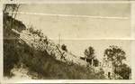 View of building and rock wall on slope, Bribane, c1936