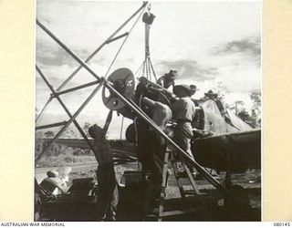 NADZAB, NEW GUINEA. 1944-06-26. A P-40 CURTISS KITTYHAWK AIRCRAFT AT NO. 4 TACTICAL RECONNAISSANCE SQUADRON, ROYAL AUSTRALIAN AIR FORCE, UNDER MINOR INSPECTION. THESE OVERHAULS ARE CARRIED OUT AT ..