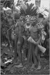 Bride price ritual: bride with feather headdress, surrounded by kin