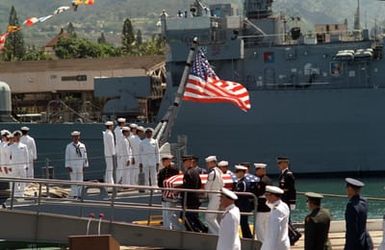 Upon completion of ceremonies, the flag draped casket of the Unknown Soldier of the Vietnam War is carried aboard the frigate USS BREWTON (FF 1086) by a joint service honor guard. The casket will be transported to Alameda, California, and then transferred