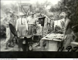 AITAPE, NORTH EAST NEW GUINEA. C. 1944-06. ARTHUR DRAKEFORD, THE MINISTER FOR AIR, ACCOMPANIED BY AIR COMMODORE F. R. W. SCHERGER, THE AIR OFFICER COMMANDING NO. 10 GROUP RAAF, AND OTHER RAAF ..