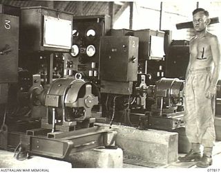 LAE BASE AREA, NEW GUINEA. 1944-12-27. A SECTION OF THE POWER HOUSE SHOWING THREE OF THE FOUR MODERN 25KVA GENERATING SETS BUILT BY THE KALGOORLIE FOUNDRY COMPANY LTD. IN THE RIGHT FOREGROUND IS ..