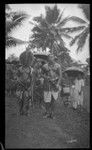 Group of people, two men in front wearing traditional samoan clothing