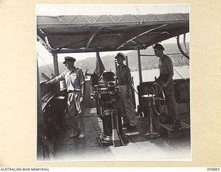 WEWAK HARBOUR, NEW GUINEA. 1945-09-03. CAPTAIN W.E. MORTLOCK (1) ON THE BRIDGE OF THE TROOPSIDE SS RIVER FITZROY. THE VESSEL, 5100 GROSS TONNAGE, LENGTH 432 FT, WIDTH 56 FT AND DEPTH OF 25 FT, HAS ..