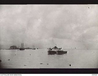 MILNE BAY, NEW GUINEA, 1943-07-11. MILNE BAY HARBOUR FROM GILI GILI. IN THE HARBOUR ARE CRAFT FROM USA FREIGHTERS AND SMALL CRAFT FROM THE AMERICAN AND AUSTRALIAN ARMIES