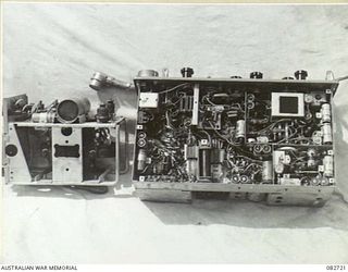 MADANG, NEW GUINEA. 1944-10-12. THE NO. 19M2 SET FROM BELOW INDICATING THE POWER UNIT AND RECEIVER. THE SET IS USED IN SHERMAN TANKS ENGAGED IN TESTS AT HQ 4 ARMOURED BRIGADE