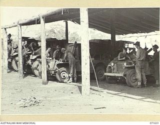 LAE, NEW GUINEA. 1944-03-24. CRAFTSMEN WORKING ON TRUCKS IN THE MOTOR REPAIR SECTION AT THE 2/125TH BRIGADE WORKSHOP ATTACHED TO THE 7TH DIVISION. IDENTIFIED PERSONNEL ARE: NX18251 CRAFTSMAN (CFN) ..