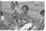 Women making baskets for food from the earth ovens.