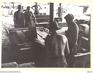CAPE CUNNINGHAM, NEW BRITAIN, 1944-12-16. 2/2 FORESTRY COY TROOPS WORKING AT NO. 1 RIP SAW BENCH