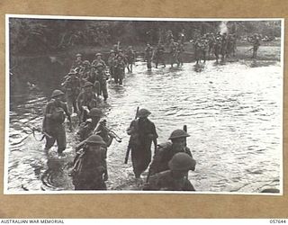 MARINGGUSIN, NEW GUINEA, 1943-09-29. "D" COMPANY, 2/14TH AUSTRALIAN INFANTRY BATTALION, 21ST AUSTRALIAN INFANTRY BRIGADE CROSSING THE YATI RIVER DURING THE MARCH FROM THE UMI RIVER TO MARRAWASA