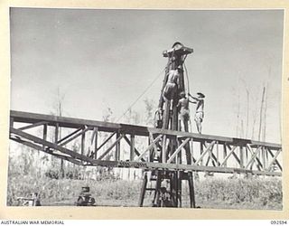 SOUTH BOUGAINVILLE, 1945-05-27. ENGINEERS OF 11 FIELD COMPANY ROYAL AUSTRALIAN ENGINEERS, WORKING ON THE SAVIGE BRIDGE OVER THE JABA NO. 1 RIVER. CONSTRUCTED IN FIVE WEEKS, THE BRIDGE MEASURES 620 ..