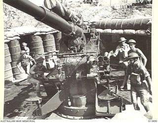 1942-11-06. SHOT OF AN AUSTRALIAN ANTI-AIRCRAFT BATTERY SOMEWHERE IN NEW GUINEA. THIS BATTERY IS MANNED ENTIRELY BY VICTORIANS USING GUNS MANUFACTURED IN A VICTORIAN FACTORY, AND THEIR BAG ENEMY ..