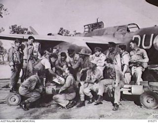 1943-07-16. NEW GUINEA. MEMBERS OF AN AUSTRALIAN BOSTON BOMBER UNIT DISCUSS THEIR BOMBING ATTACK ON MUBO - THE GREATEST SINGLE RAID YET MADE ON A LAND TARGET IN THE SOUTHWEST PACIFIC. OVER 50 ..