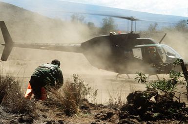 An Army helicopter lands to rescue combat control team member 1ST LT. Doug Bennett during search and rescue training conducted as part of Exercise Cope Elite '81. 1ST LT. Bennett is from the 22nd Tactical Air Support Squadron