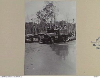 WARINGE RIVER, WEWAK AREA, NEW GUINEA, 1945-05-13. SAPPERS OF 8 PLATOON, 2/8 FIELD COMPANY, ROYAL AUSTRALIAN ENGINEERS, CONSTRUCTING A PERMANENT BRIDGE BESIDE A TEMPORARY PONTOON BRIDGE OF FOLDING ..