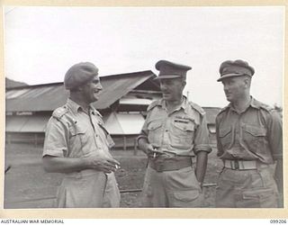 RABAUL, NEW BRITAIN, 1945-11-27. OFFICERS OF 5 BASE SUB AREA AT THEIR HEADQUARTERS IN MALAGUNA ROAD. LIEUTENANT-COLONEL R.P. MCLELLAN, CO, (1) MAJOR A.G. ROWELL, SECOND IN CHARGE (2), AND CAPTAIN ..