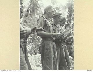 KARKAR ISLAND, NEW GUINEA. 1944-06-02. MEMBERS OF THE 37/52ND INFANTRY BATTALION SINGING HYMNS DURING AN OPEN AIR CHURCH OF ENGLAND SERVICE AT BISON BAY. IDENTIFIED PERSONNEL ARE:- VX71515 PRIVATE ..