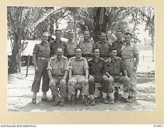 NADZAB, NEW GUINEA. 1944-05-25. OFFICERS OF THE 3RD AIR MAINTENANCE COMPANY AT THEIR HEADQUARTERS. IDENTIFIED PERSONNEL ARE:- VX81185 LIEUTENANT G.H. COOK (1); NX70160 MAJOR D.S. ESPLIN, COMMANDING ..