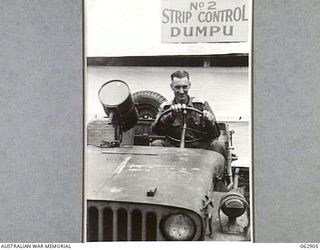 DUMPU, NEW GUINEA. 1944-01-16. VX16389 LIEUTENANT F. J. BOLITHO OF THE 7TH AUSTRALIAN DIVISION STRIP COMMAND, ASSISTANT STRIP CONTROLLER AT NO. 2 STRIP, IN THE UNIT JEEP