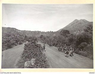 MALAGUNA, RABAUL AREA, NEW BRITAIN, 1945-09-10. TROOPS OF 4 INFANTRY BRIGADE, WHO OCCUPIED RABAUL AFTER THE JAPANESE SURRENDER, MARCHING ALONG MALGUNA ROAD TOWARDS THE TOWNSHIP