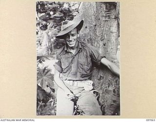 RABAUL, NEW BRITAIN. 1945-09-23. CORPORAL A.F. THOMAS, 37/52 INFANTRY BATTALION, GUARDING THE ENTRANCE TO A TUNNEL. THE JAPANESE GARRISON AT RABAUL MADE EXTENSIVE USE OF TUNNELS AFTER ABOVEGROUND ..