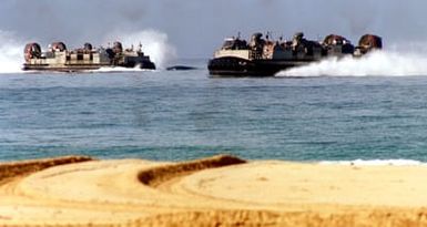 An all-enlisted crew pilots a Landing Craft Air Cushion (LCAC) to the shore of Pacific Missle Range Facility, Barking Sands, Kauai, Hawaii, during an amphibious assault with Marines from 11th Marine Expeditionary Unit, Camp Pendleton, California, as part of RIMPAC 96. The amphibious landing was conducted by 11th MEU and involved Navy and Marine air, ground and sea forces for training as a combined amphibious assault force