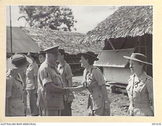 LAE, NEW GUINEA. 1945-05-11. GENERAL SIR THOMAS A. BLAMEY, COMMANDER-IN-CHIEF, ALLIED LAND FORCES, SOUTH WEST PACIFIC AREA (1), SHAKING HANDS WITH LIEUTENANT S.H. BUDGE (2), DURING AN INSPECTION OF ..