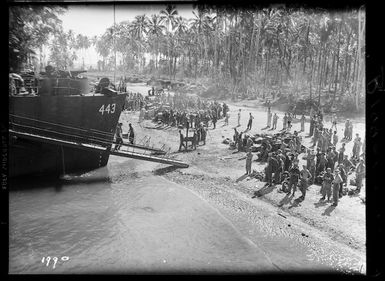 New Zealand World War II soldiers loading stores into infantry landing craft, Vella Lavella, Solomon Islands