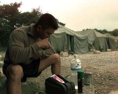 LCPL Joe Federico from the 2d Battalion, 8th Marines, out of Camp Lejeune, N.C., brushes his teeth at Marine Expeditionary Camp-Pohang (MEC-P), Oct. 11, 1998. Federico, originally from Honolulu, Hawaii, is a baker deployed to MEC-P in support of Foal Eagle '98