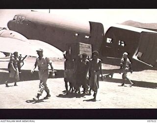 NADZAB AIRSTRIP, NEW GUINEA. 1943-09-19. NATIVES UNLOADING SUPPLIES AT NO. 2 AIRSTRIP