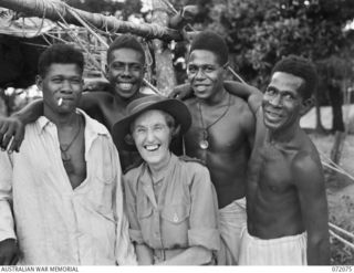 HELDSBACH PLANTATION, NEW GUINEA. 1944-04-06. NFX76394 SENIOR SISTER E.B.Y. CAMERON (1), WITH SOME OF THE MEMBERS OF THE PAPUAN INFANTRY BATTALION WHO ARE CONVALESCING AT THE 106TH CASUALTY ..