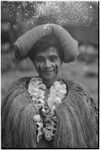 New mother wearing long fiber shawl, flower garland, cloth on her head, marks on face