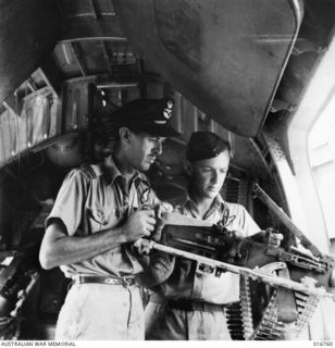 1944-03-29. NEW GUINEA. BEFORE THIS RAAF-MANNED LIBERATOR AIRCRAFT TOOK OFF TO ATTACK JAPANESE STRONGHOLDS IN THE SOUTHWEST PACIFIC AREA, F/O A. DUCAT D.F.M. OF PERTH, W.A. CHECKED ONE OF THE GUNS ..