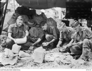 ALEXISHAFEN, NEW GUINEA. 1944-05-11. PERSONNEL AT ALEXISHAFEN, FIELD POST OFFICE 156 SORT MAIL FOR DESPATCH TO UNITS OF THE 8TH INFANTRY BRIGADE. IDENTIFIED PERSONNEL ARE:- NX120873 SERGEANT J.L. ..