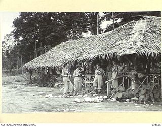 LAE, NEW GUINEA. 1944-07-14. SISTERS OF THE 2/7TH AUSTRALIAN GENERAL HOSPITAL OUTSIDE THEIR THATCHED ROOF MESS. IDENTIFIED PERSONNEL:- VFX117174 SISTER D. BARCLAY (1); NFX70518 SISTER M.M. OLLIFFE ..