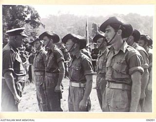 Major General W Bridgeford, General Officer Commanding 3rd Division, accompanied by Brigadier H H Hammer, Commander 15th Infantry Brigade, congratulating winners of the Mention in Despatches award. ..