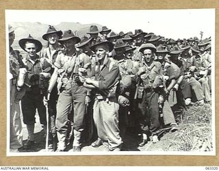 DUMPU, NEW GUINEA. 1944-01-03. PERSONNEL OF C COMPANY, 2/12TH INFANTRY BATTALION, 18TH INFANTRY BRIGADE, ON THEIR ARRIVAL AT THE AIRSTRIP FROM PORT MORESBY, PAPUA. IDENTIFIED PERSONNEL ARE: PRIVATE ..