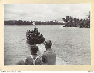 BUKA PASSAGE, BOUGAINVILLE. 1945-09-14. A MOTOR LAUNCH CARRYING MEMBERS OF HEADQUARTERS 2 CORPS, PREPARED FOR SURRENDER DISCUSSIONS WITH THE JAPANESE, MET THE JAPANESE BARGE AT A SEA RENDEZVOUS OFF ..