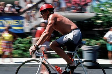 Major (MAJ) Gary Castelli, a member of the US Air Force, takes part in the 112-mile the bicycle race, part of the 1987 Ironman Competition