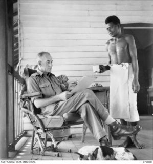 LITTLE EDIE CREEK, NEW GUINEA, 1944-02-25. N21163 CAPTAIN A.J. WATSON, AREA COMMANDANT AT THE WAU HEADQUARTERS AREA COMPOUND IN HIS OFFICE