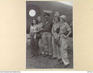 BORAM AIRSTRIP, WEWAK AREA, NEW GUINEA. 1945-09-28. MEMBERS OF THE DARYA COLLIN BALLET TROUPE WHICH IS CURRENTLY TOURING THE SOUTH WEST PACIFIC AREA ENTERTAINING TROOPS. SHOWN WITH THE GROUP IS ..