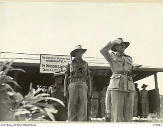 LAE, NEW GUINEA, 1944-03-08. VX20308 MAJOR-GENERAL F.H. BERRYMAN, CBE, DSO (1), GENERAL OFFICER COMMANDING 2ND AUSTRALIAN CORPS, TAKES THE SALUTE DURING THE MARCH PAST OF THE 29TH INFANTRY BRIGADE. ..