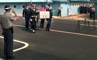 A ROK Army Guard salutes the casket of what is believed to contain the first of five U.S. soldiers killed in the Korean War who were repatriated during a ceremony at the Panmunjom Freedom House. A delegation of United Nations Command Military Armistice Commission (UNCMAC) officials received the remains from North Korean officials during the eighth repatriation ceremony held since joint search and recovery operations began in Korea in 1996. The five sets of remains brings the total returned to 19. Kim Yong-kyu, a spokesman for the U.N. command said the remains were recovered from Gaechon City, about 50 miles north of Pyongyang. The U.S. 2nd Infantry Division suffered nearly 5,000...