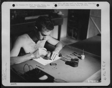 An electrical coolant guage is repaired at the instrument shop of the 27th Air Depot Group at the Port Moresby Air Depot, Papua, New Guinea. 1943. (U.S. Air Force Number 67680AC)